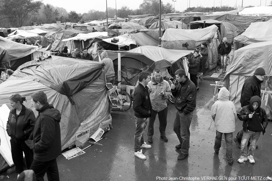 Les familles albanaises, kosovares et bosniaques ont rejoint progressivement le camp de Metz Blida. Les bâches plastique et les toiles de tente sont leurs maisons, séparées par de petites allées.